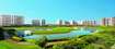Jaypee Greens_a large body of water surrounded by tall buildings